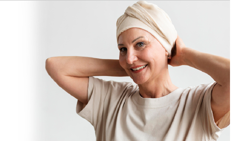 Mulher idosa com tecido na cabeça sorrindo - reabilitação do câncer